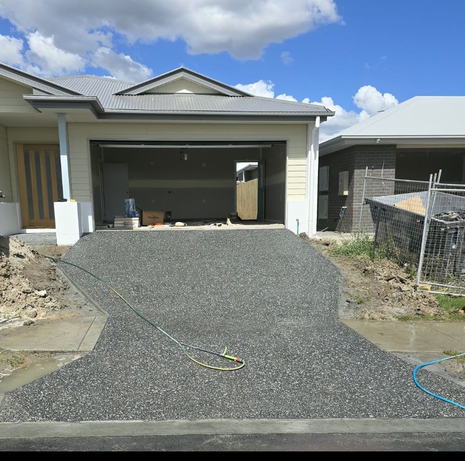 Charcoal exposed aggregate driveway running up to a double garage, Sunshine Coast