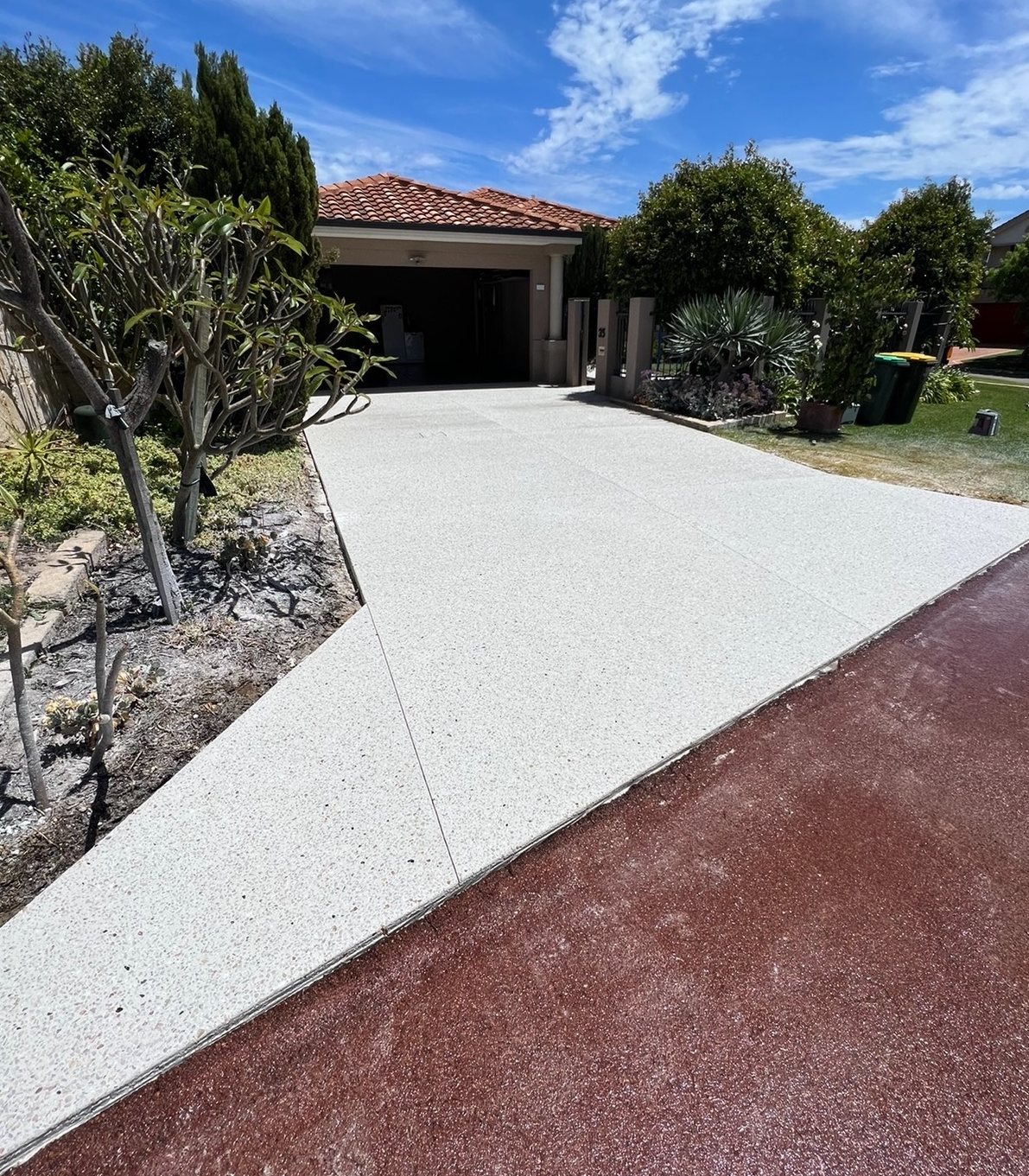 Exposed aggregate concrete driveway across a full frontage