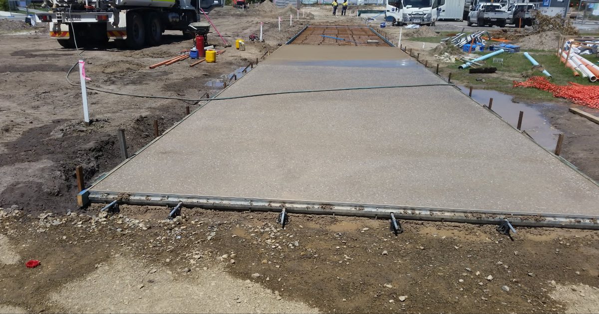 Exposed aggregate path being poured and screeded between the forms, Sunshine Coast