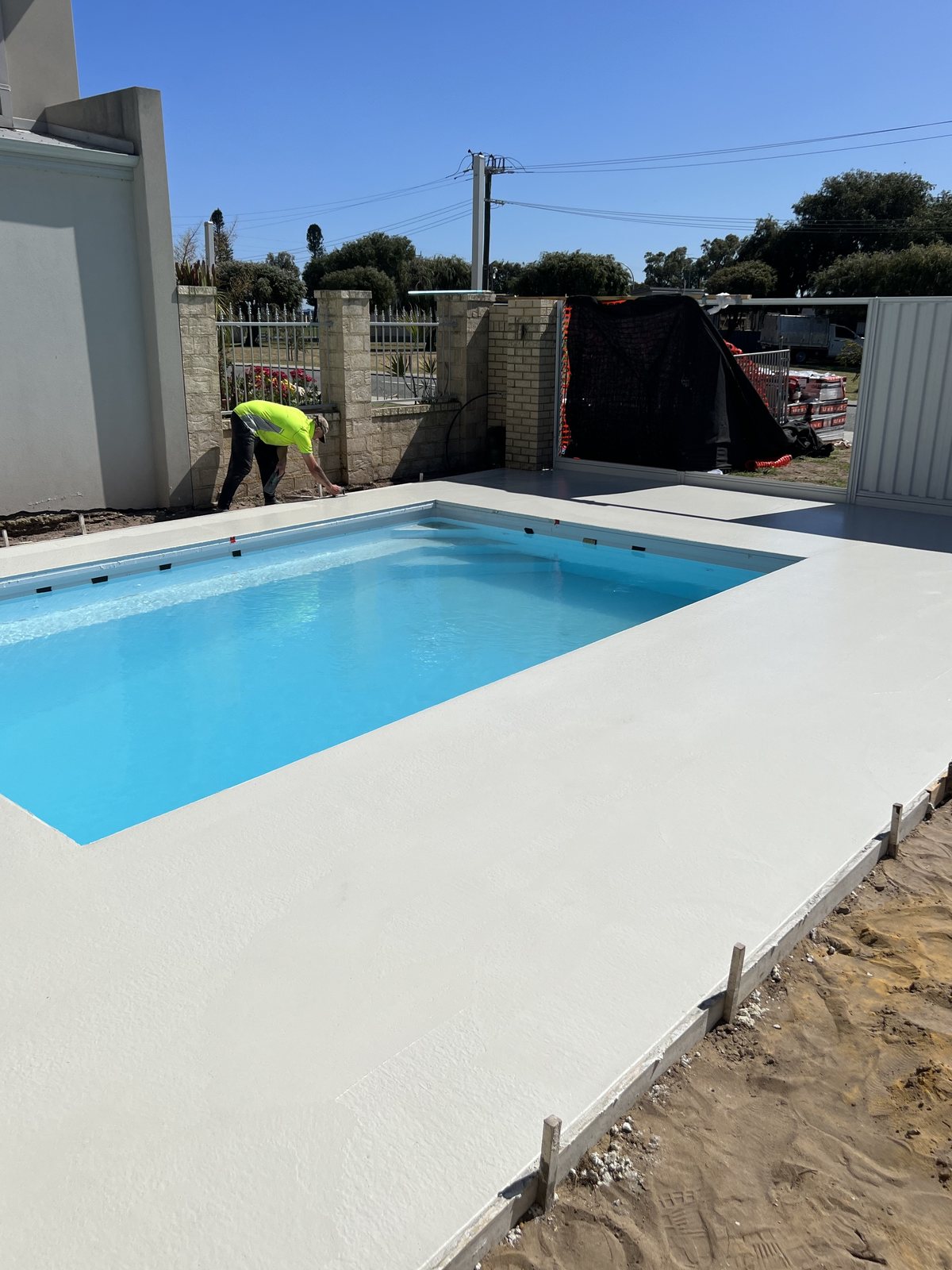 Honed concrete finish formed to a pool edge