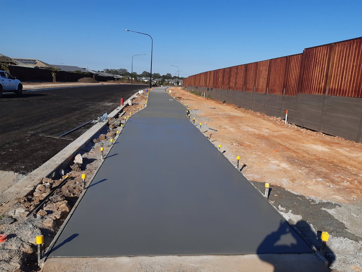 Finished plain concrete footpath on a long straight run, Sunshine Coast
